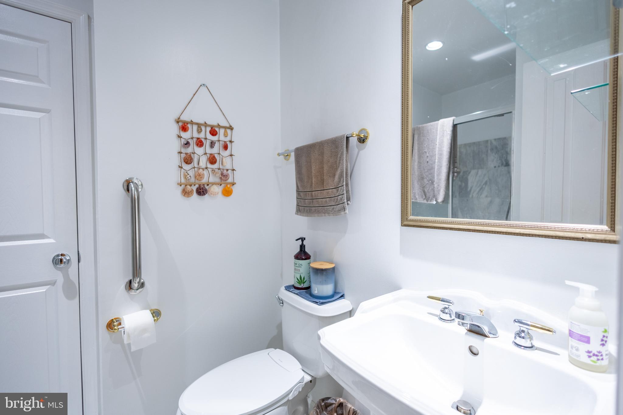 1520 O Street Northwest, Unit 104 Washington, DC 20005 - Photo 12 of 15 a bathroom with a sink mirror and toilet