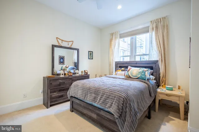 a bedroom with a bed and a dresser