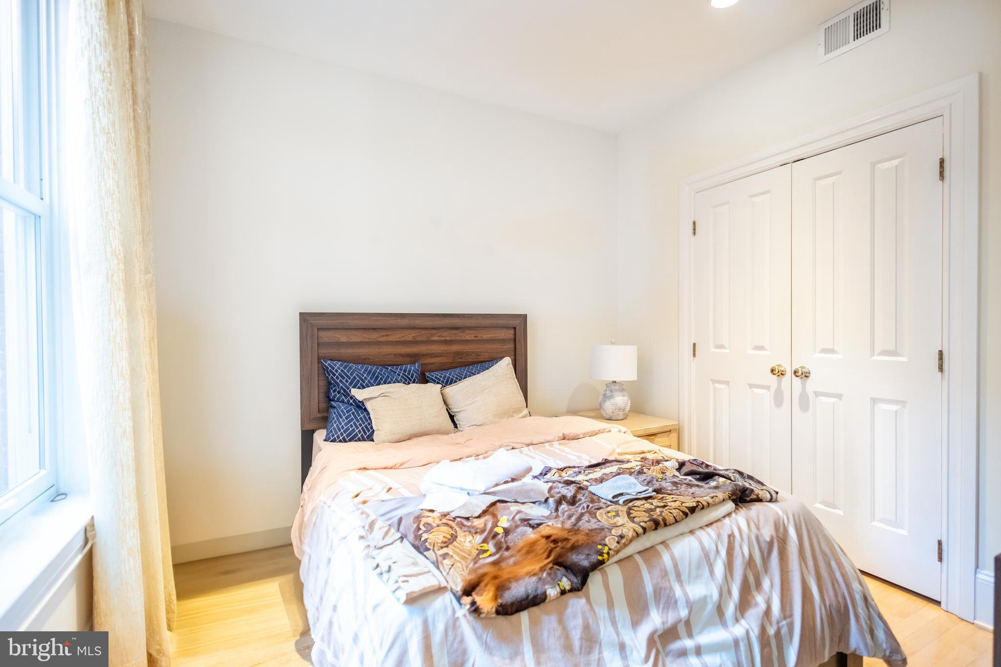 1520 O Street Northwest, Unit 104 Washington, DC 20005 - Photo 15 of 15 a bedroom with a bed and a painting on the wall