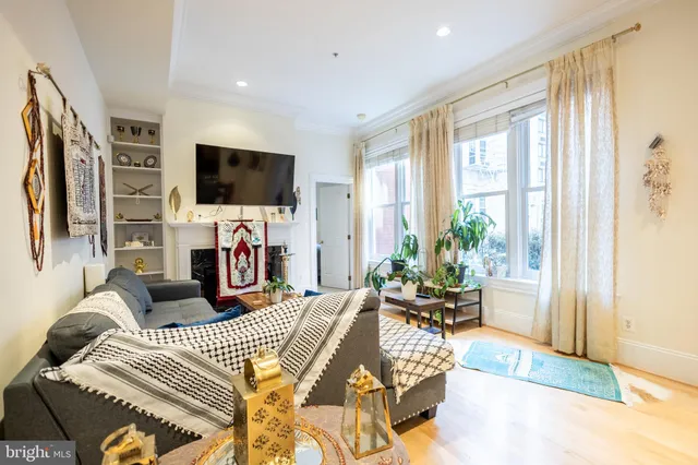 a living room with fireplace furniture and a flat screen tv