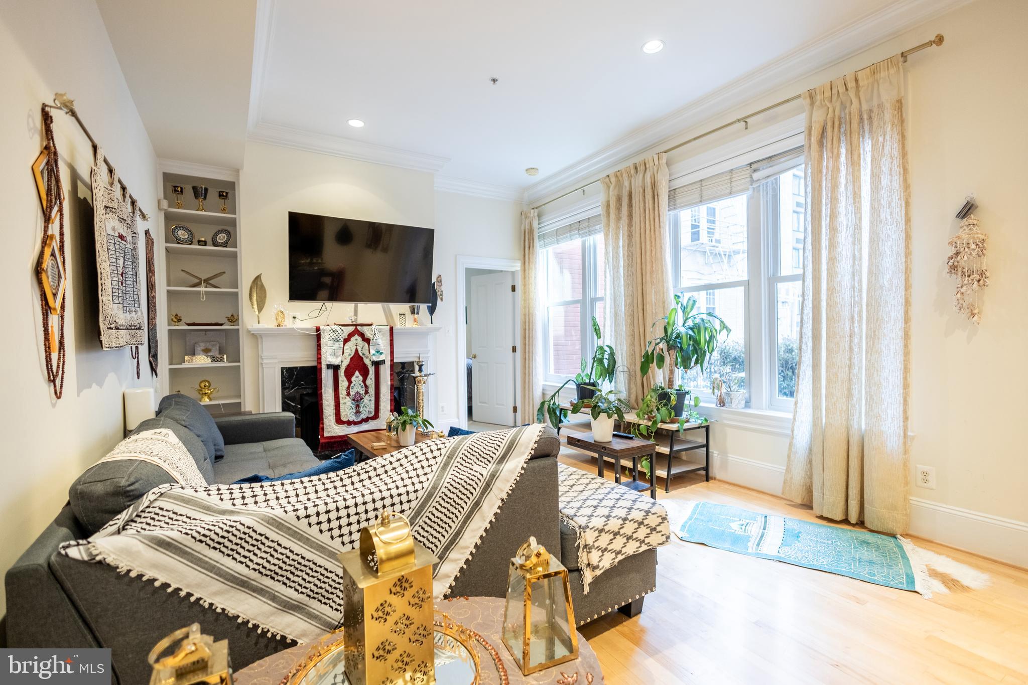 1520 O Street Northwest, Unit 104 Washington, DC 20005 - Photo 3 of 15 a living room with fireplace furniture and a flat screen tv