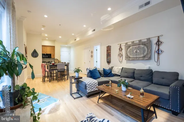 a living room with furniture and wooden floor