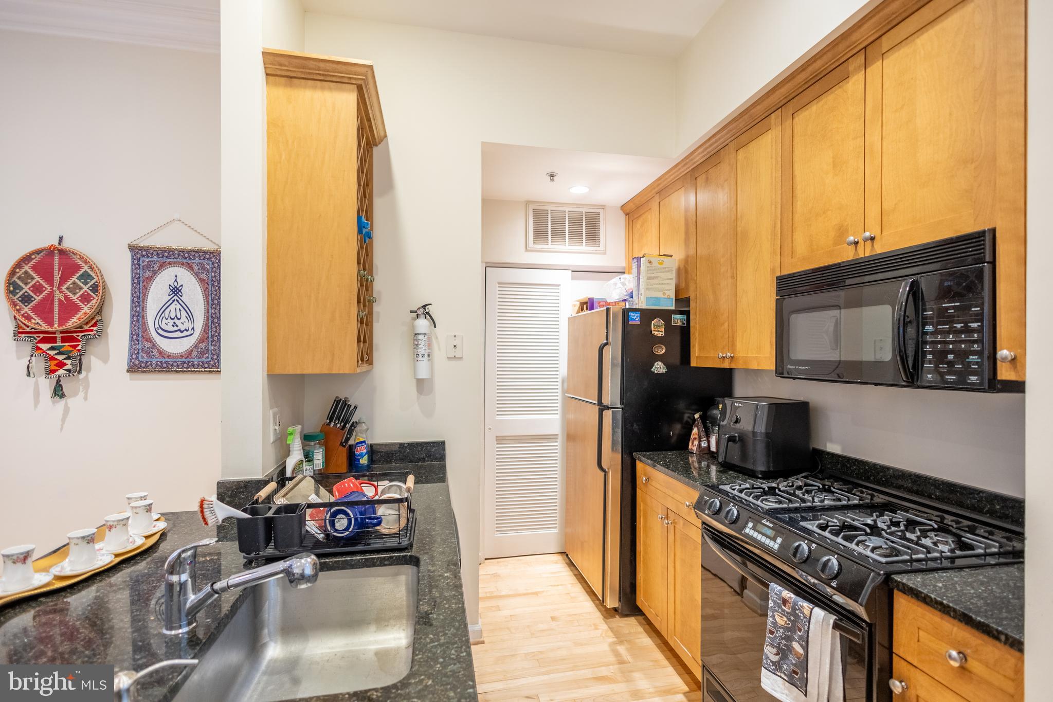 1520 O Street Northwest, Unit 104 Washington, DC 20005 - Photo 8 of 15 a kitchen with sink refrigerator and stove top oven