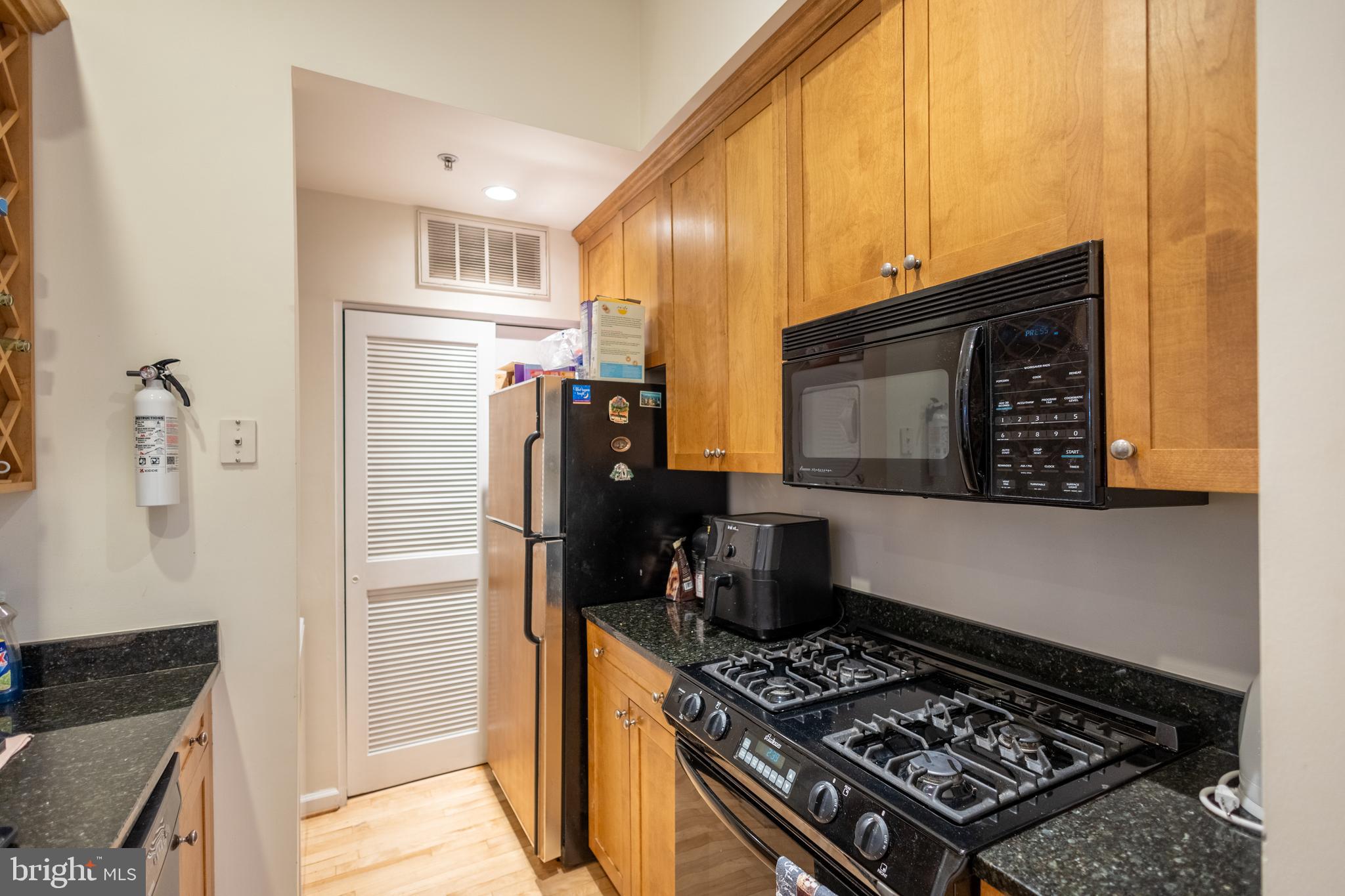 1520 O Street Northwest, Unit 104 Washington, DC 20005 - Photo 9 of 15 a kitchen with a stove and a refrigerator