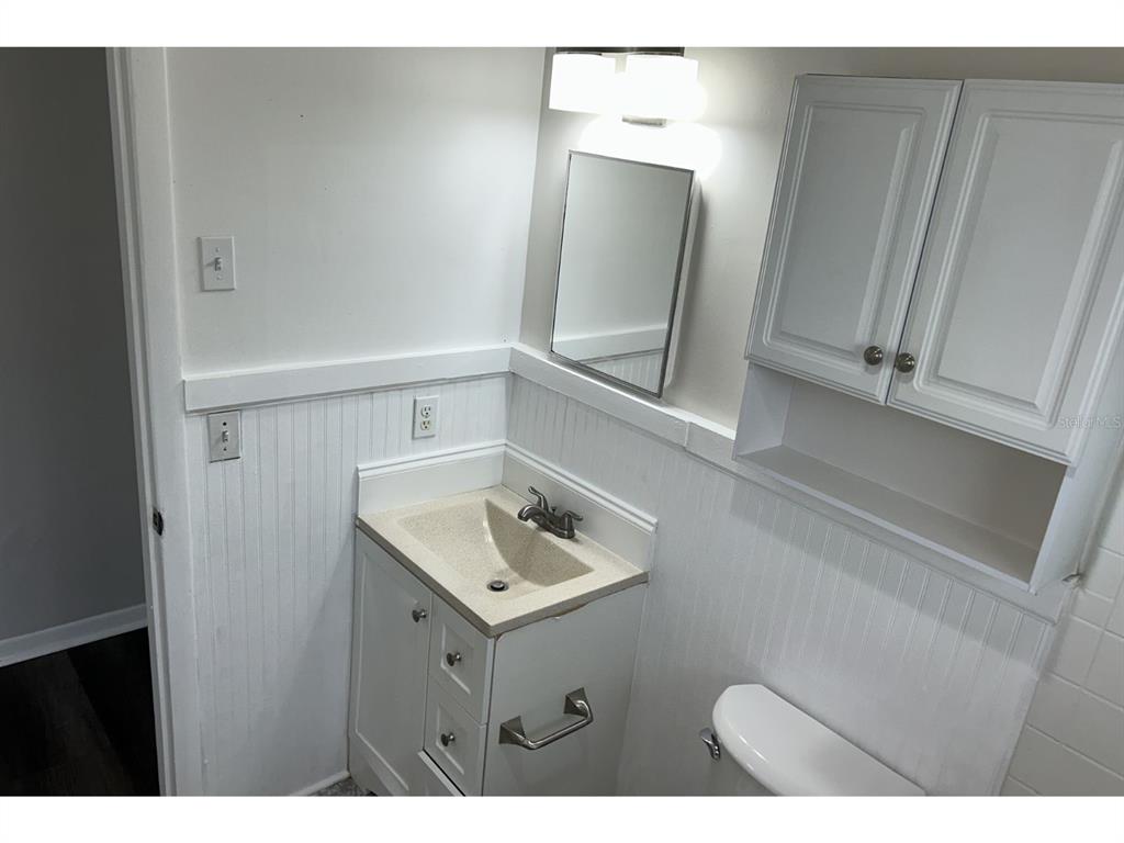 1241 Pilgrim Road Spring Hill, FL 34606 - Photo 16 of 28 a bathroom with a sink a mirror and vanity