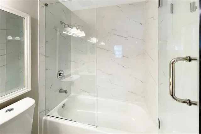 a bathroom with a bathtub and a shower