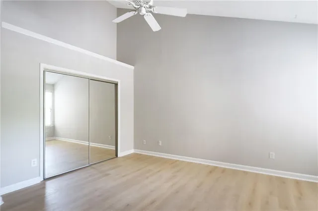 a view of an empty room with wooden floor