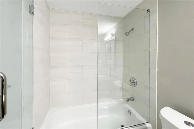 a bathroom with a shower and toilet