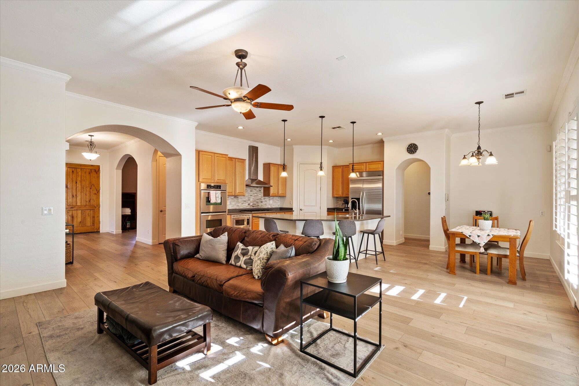 3118 South Colonial Street Gilbert, AZ 85295 - Photo 15 of 38 a living room with furniture kitchen view and a chandelier