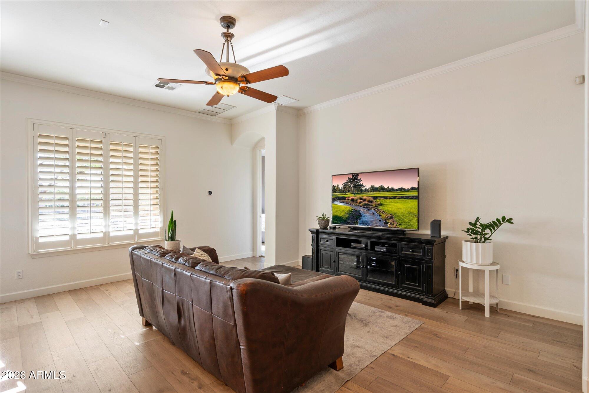 3118 South Colonial Street Gilbert, AZ 85295 - Photo 19 of 38 a living room with furniture and a flat screen tv