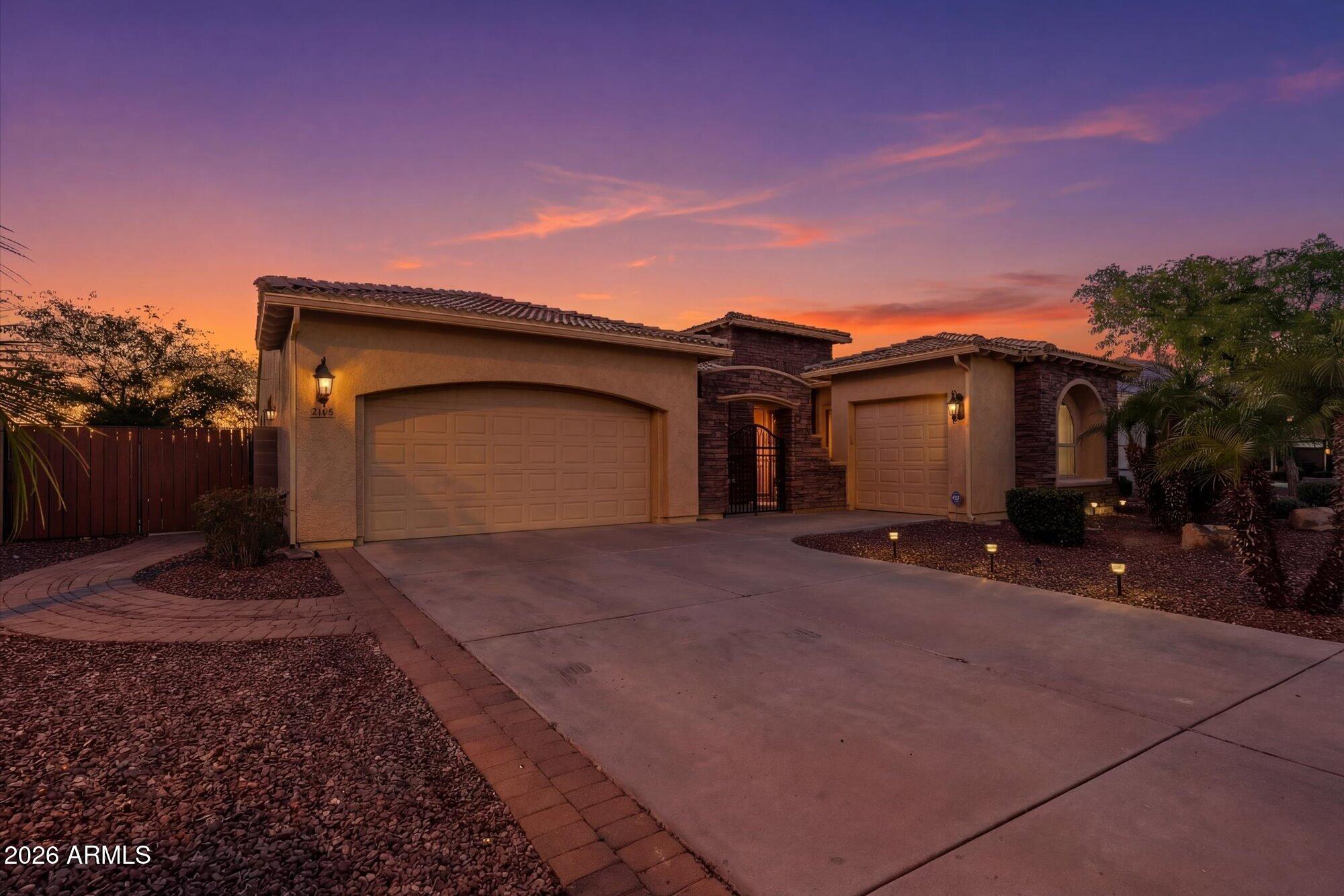 3118 South Colonial Street Gilbert, AZ 85295 - Photo 2 of 38 a front view of a house with a yard and garage