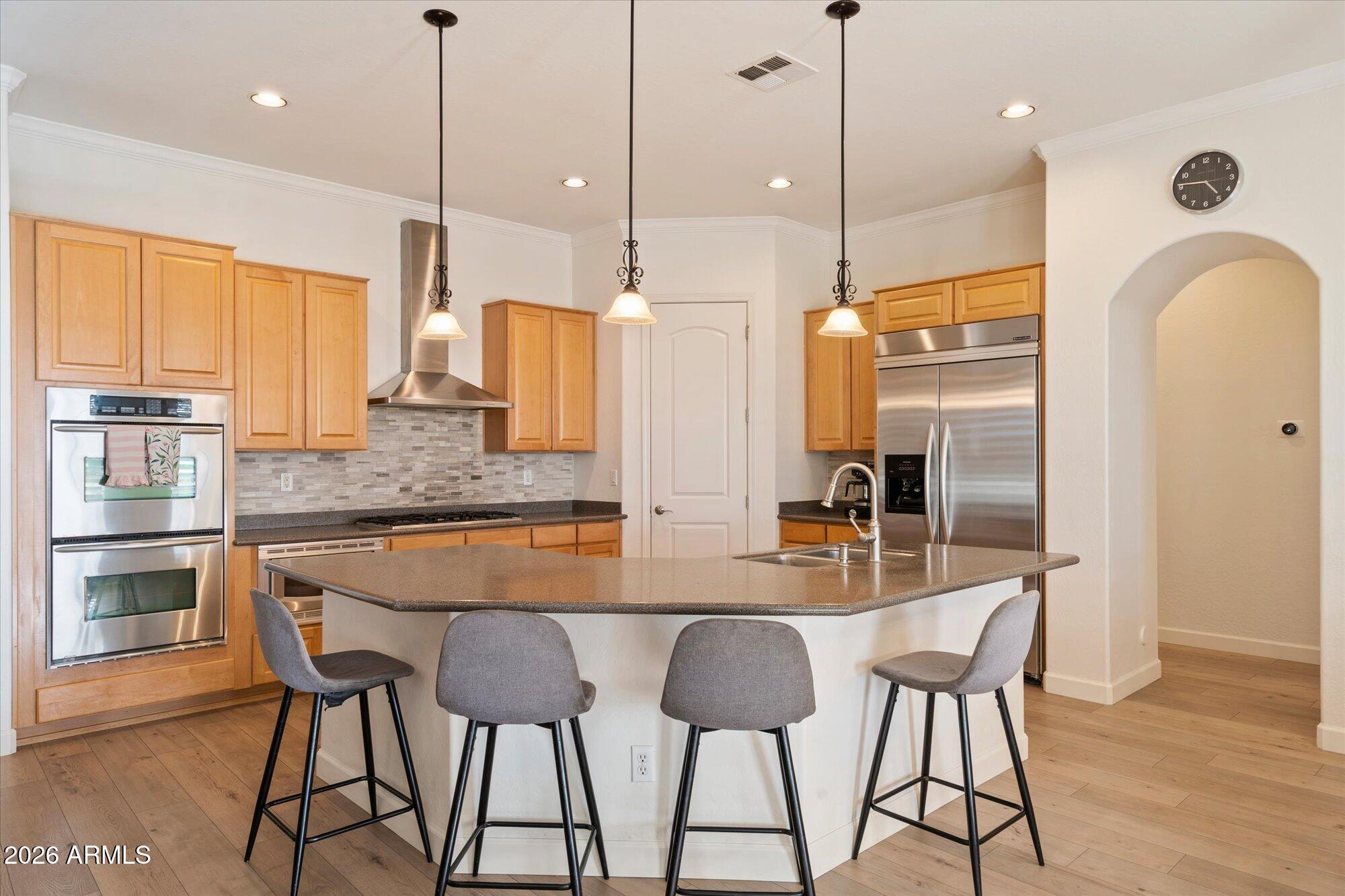 3118 South Colonial Street Gilbert, AZ 85295 - Photo 23 of 38 a kitchen with stainless steel appliances granite countertop a kitchen island a stove and a refrigerator