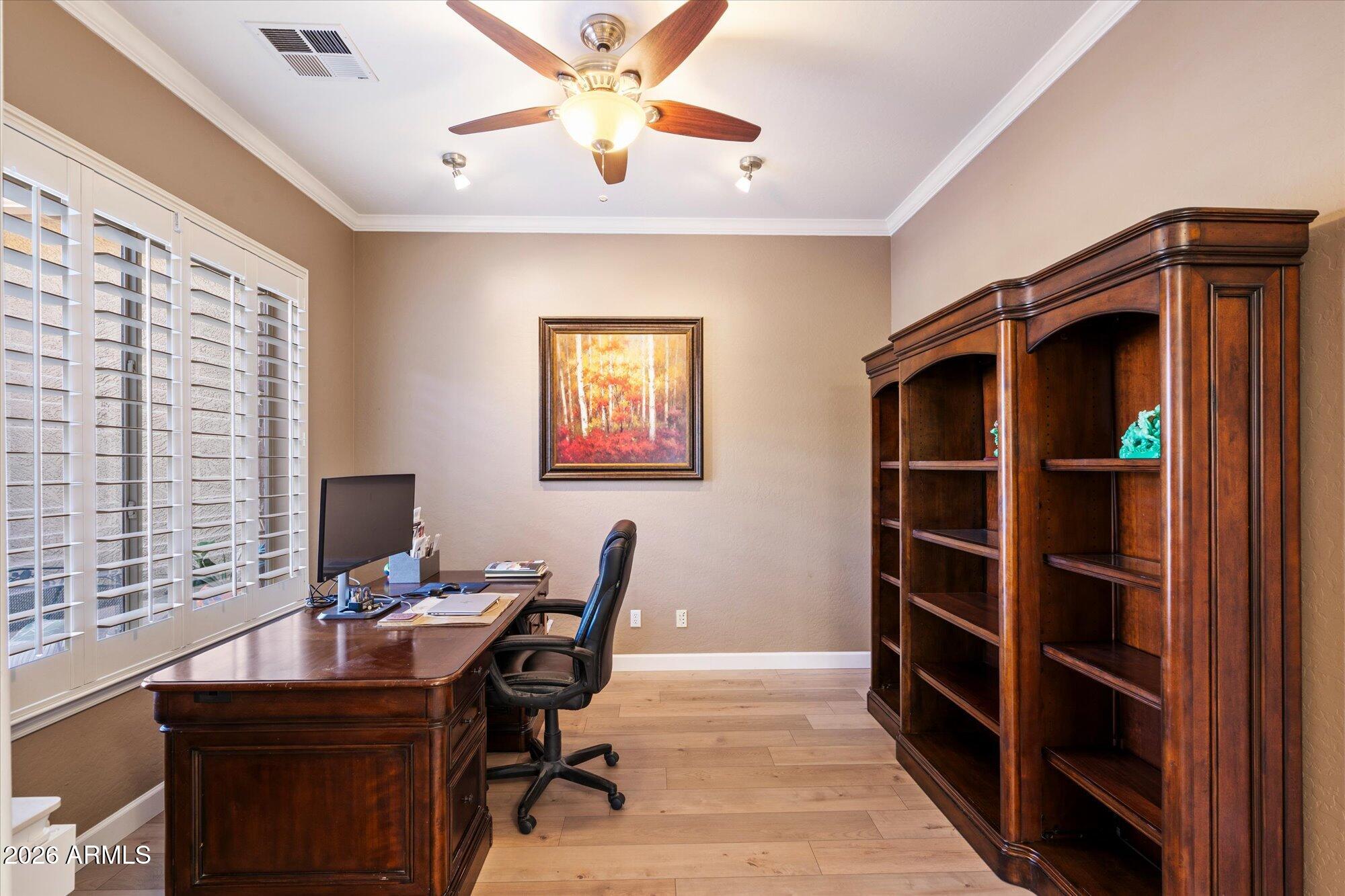 3118 South Colonial Street Gilbert, AZ 85295 - Photo 27 of 38 a view of a workspace with furniture and a window
