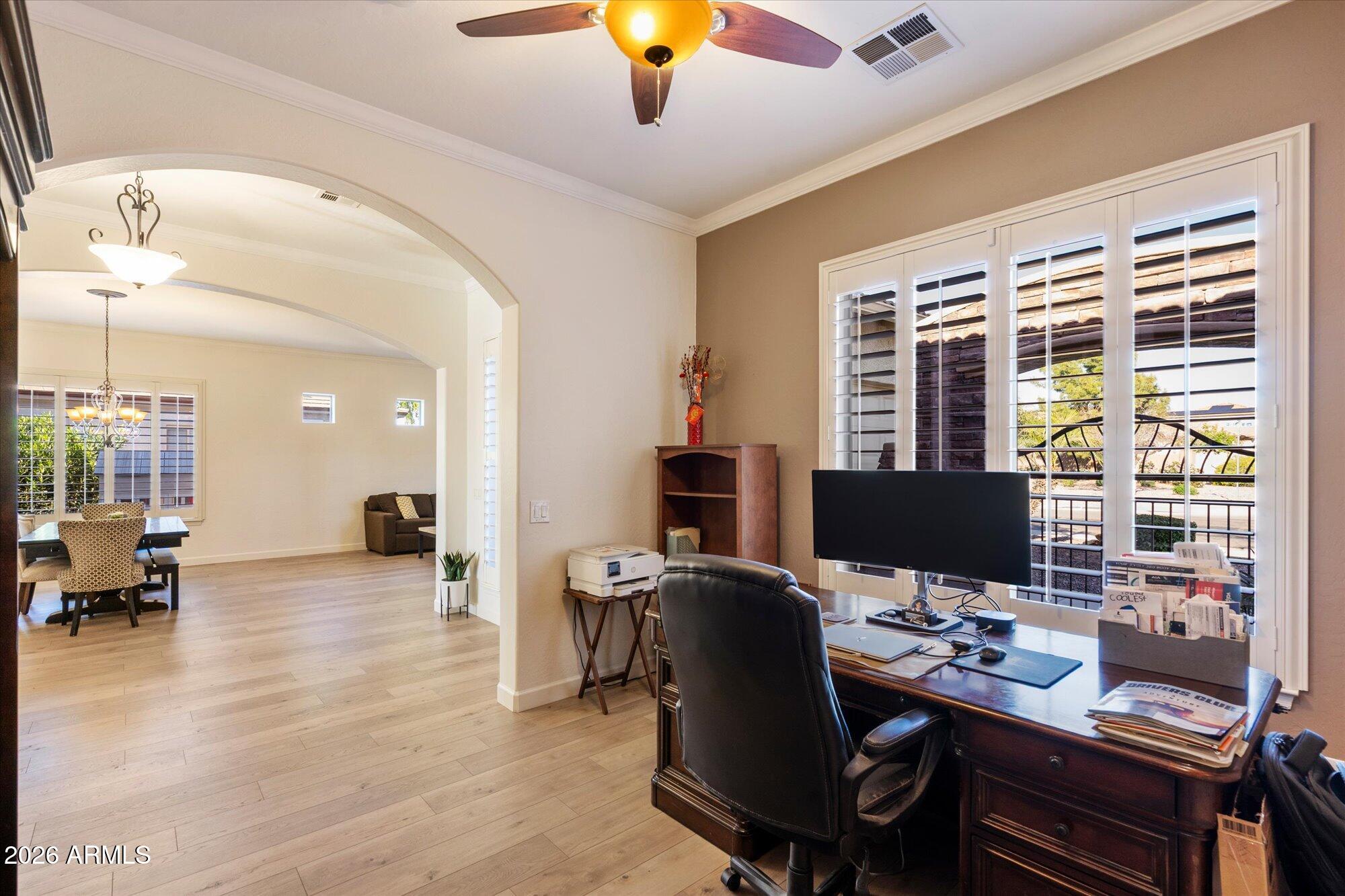 3118 South Colonial Street Gilbert, AZ 85295 - Photo 28 of 38 a view of a workspace with furniture and chandelier
