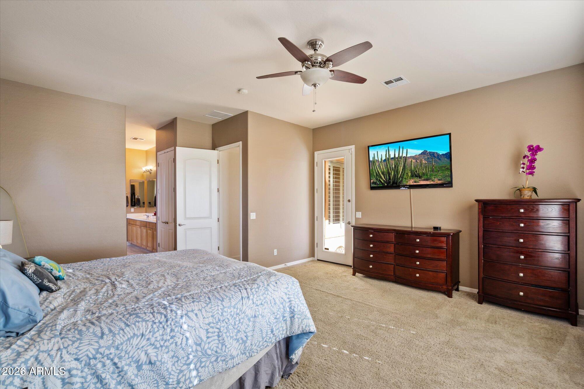 3118 South Colonial Street Gilbert, AZ 85295 - Photo 31 of 38 a bedroom with a bed and a flat screen tv