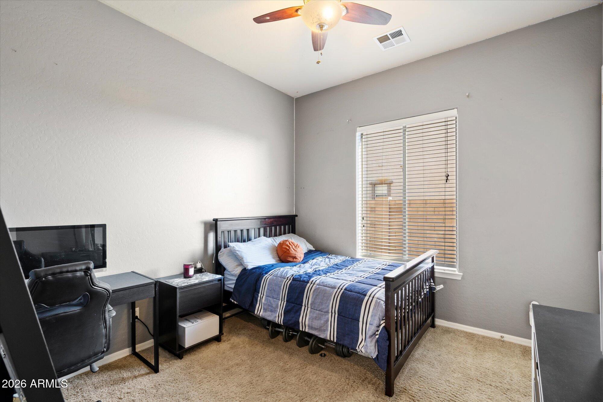 3118 South Colonial Street Gilbert, AZ 85295 - Photo 34 of 38 a bedroom with a bed and a chandelier