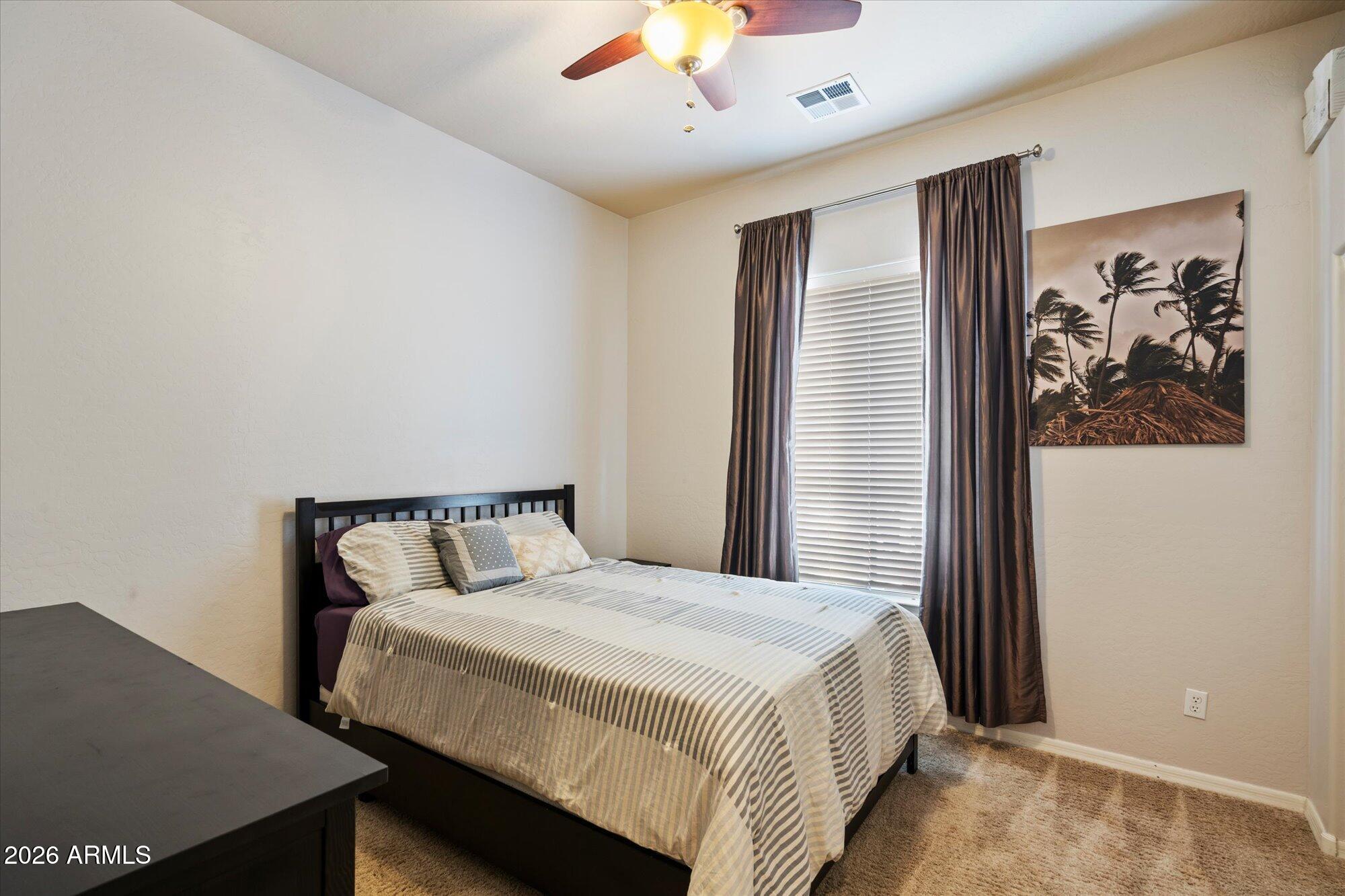 3118 South Colonial Street Gilbert, AZ 85295 - Photo 37 of 38 a bedroom with a large bed and a chandelier