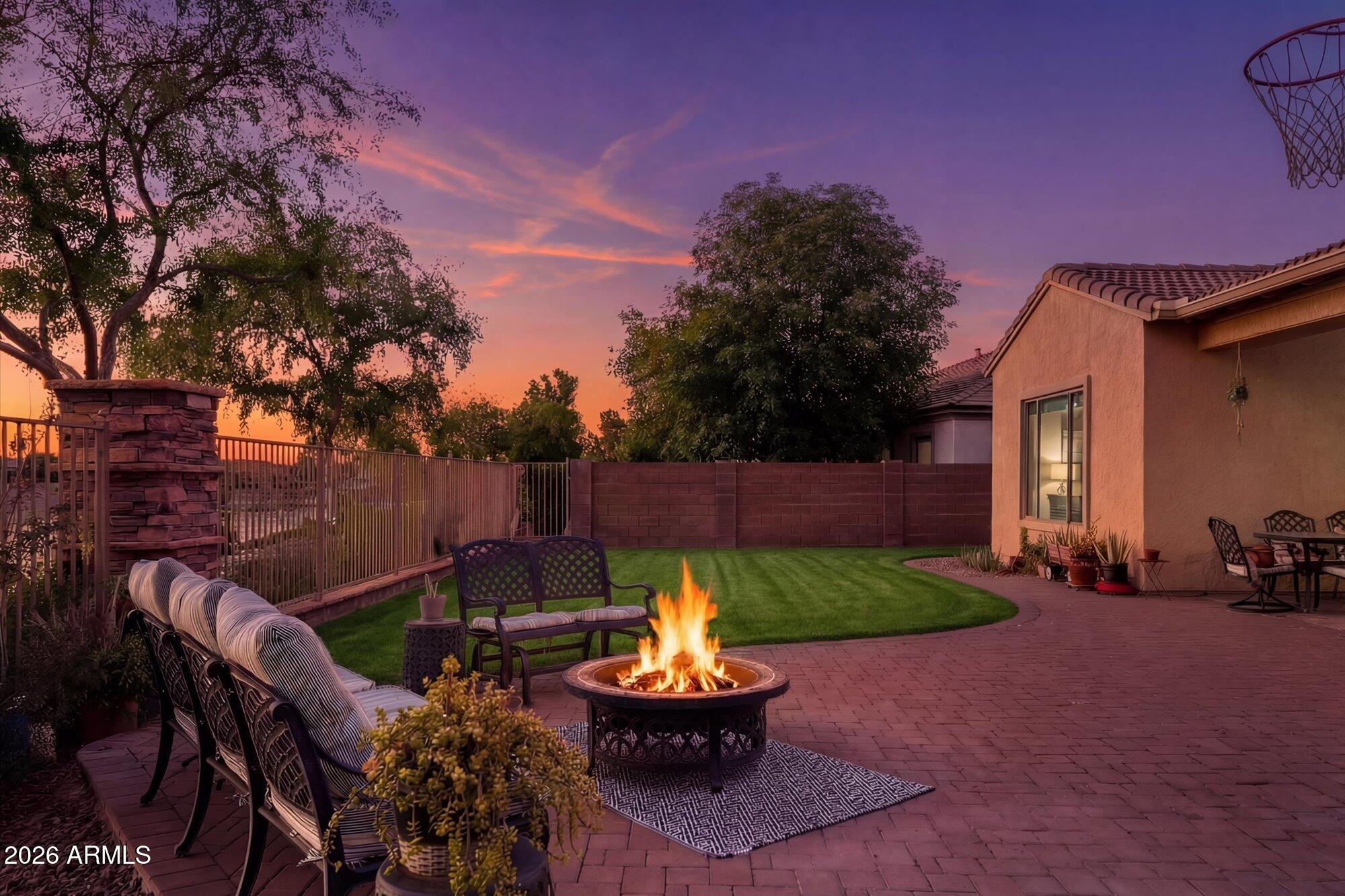 3118 South Colonial Street Gilbert, AZ 85295 - Photo 4 of 38 a table and chairs in front of a house