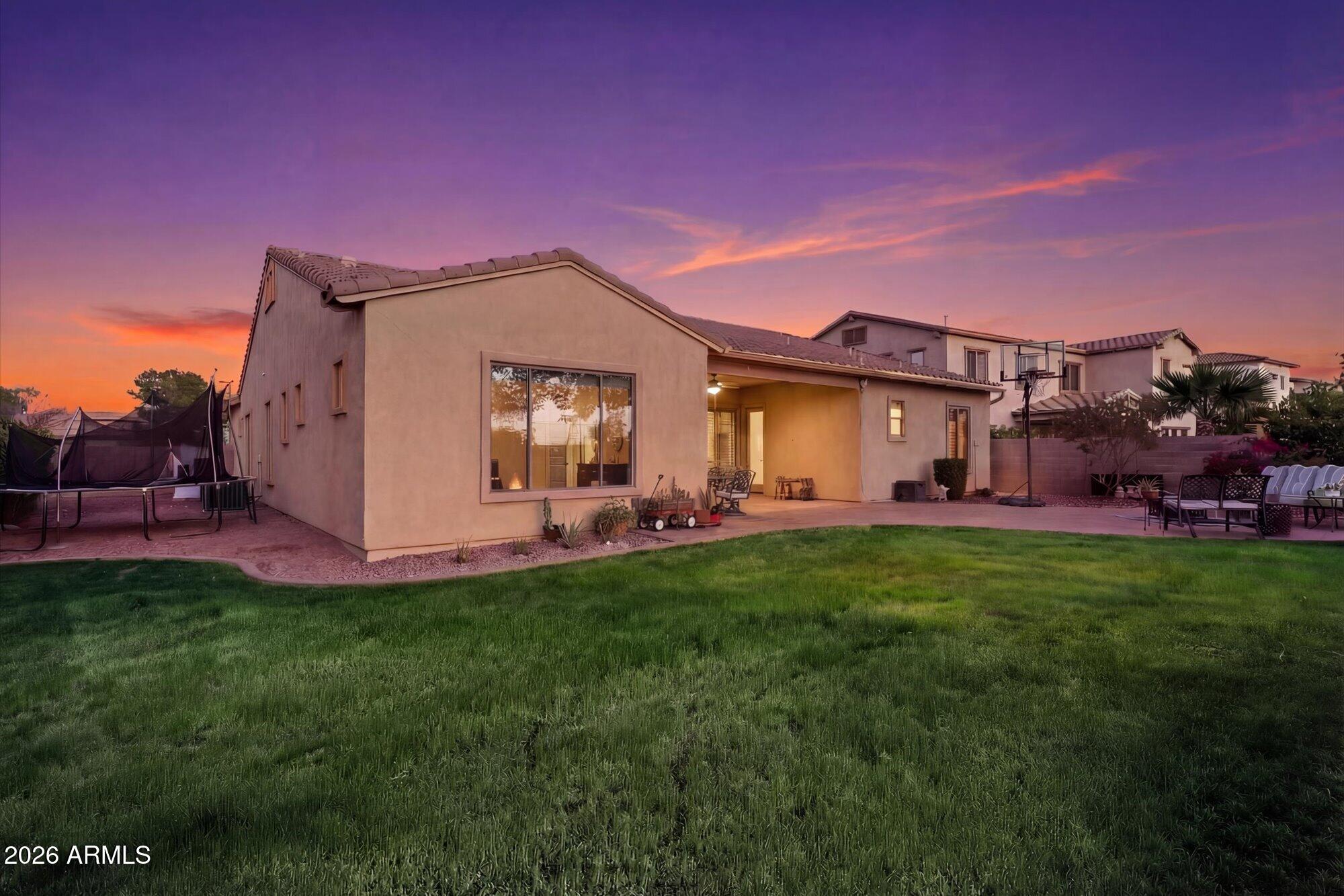 3118 South Colonial Street Gilbert, AZ 85295 - Photo 5 of 38 a front view of a house with a garden and yard