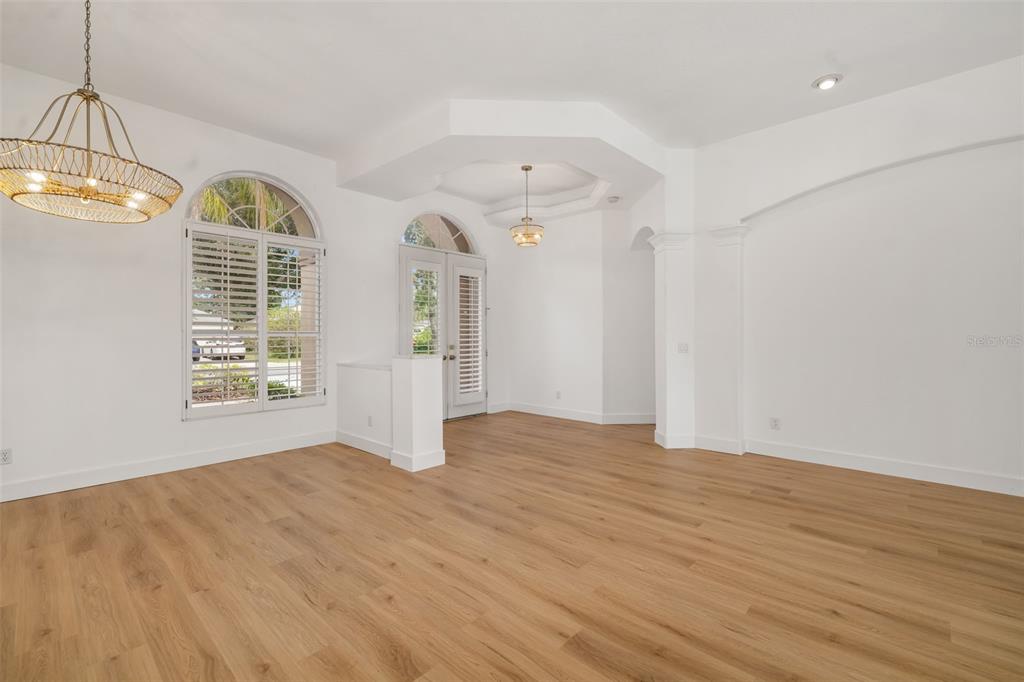 11022 Pine Lilly Place Lakewood Ranch, FL 34202 - Photo 19 of 61 a view of an empty room with wooden floor and a window