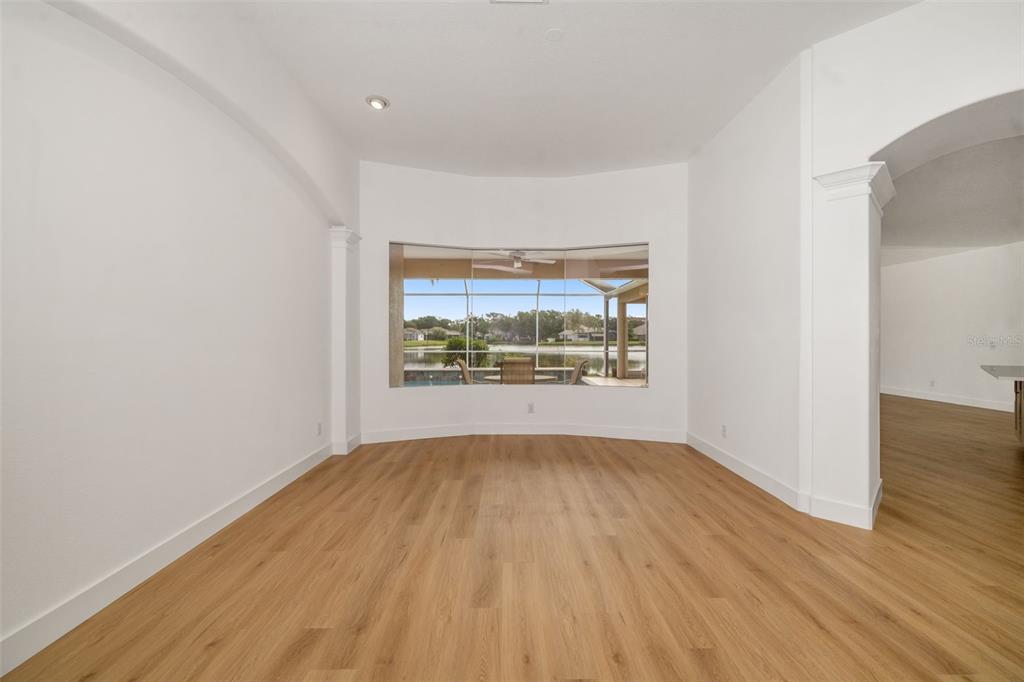 11022 Pine Lilly Place Lakewood Ranch, FL 34202 - Photo 22 of 61 a view of an empty room with wooden floor and a window