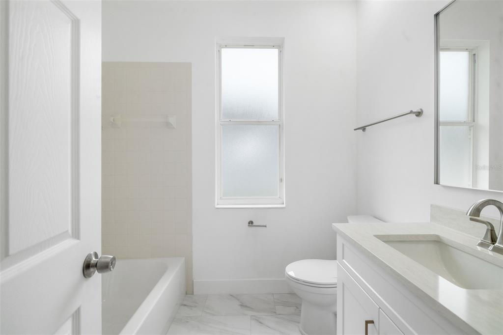 11022 Pine Lilly Place Lakewood Ranch, FL 34202 - Photo 39 of 61 a bathroom with a sink toilet and tub