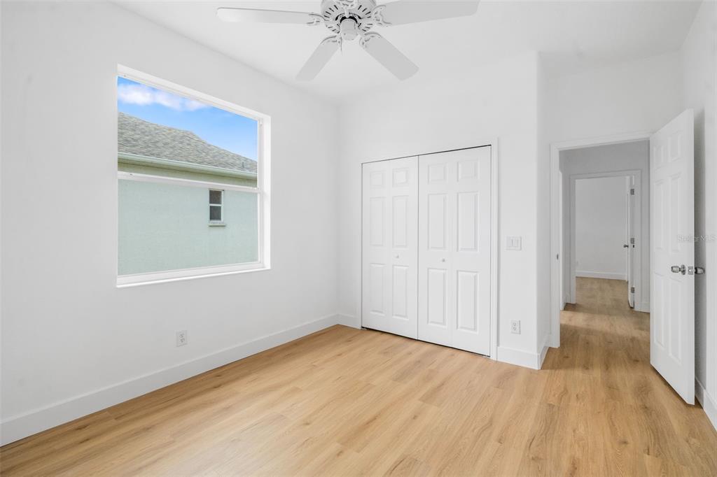 11022 Pine Lilly Place Lakewood Ranch, FL 34202 - Photo 40 of 61 wooden floor in an empty room with a window
