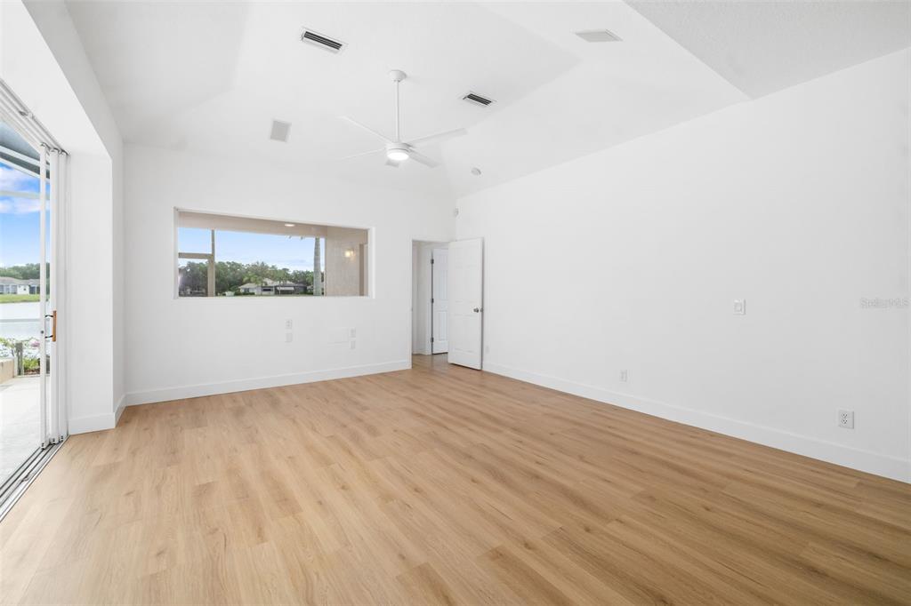 11022 Pine Lilly Place Lakewood Ranch, FL 34202 - Photo 49 of 61 an empty room with wooden floor and windows