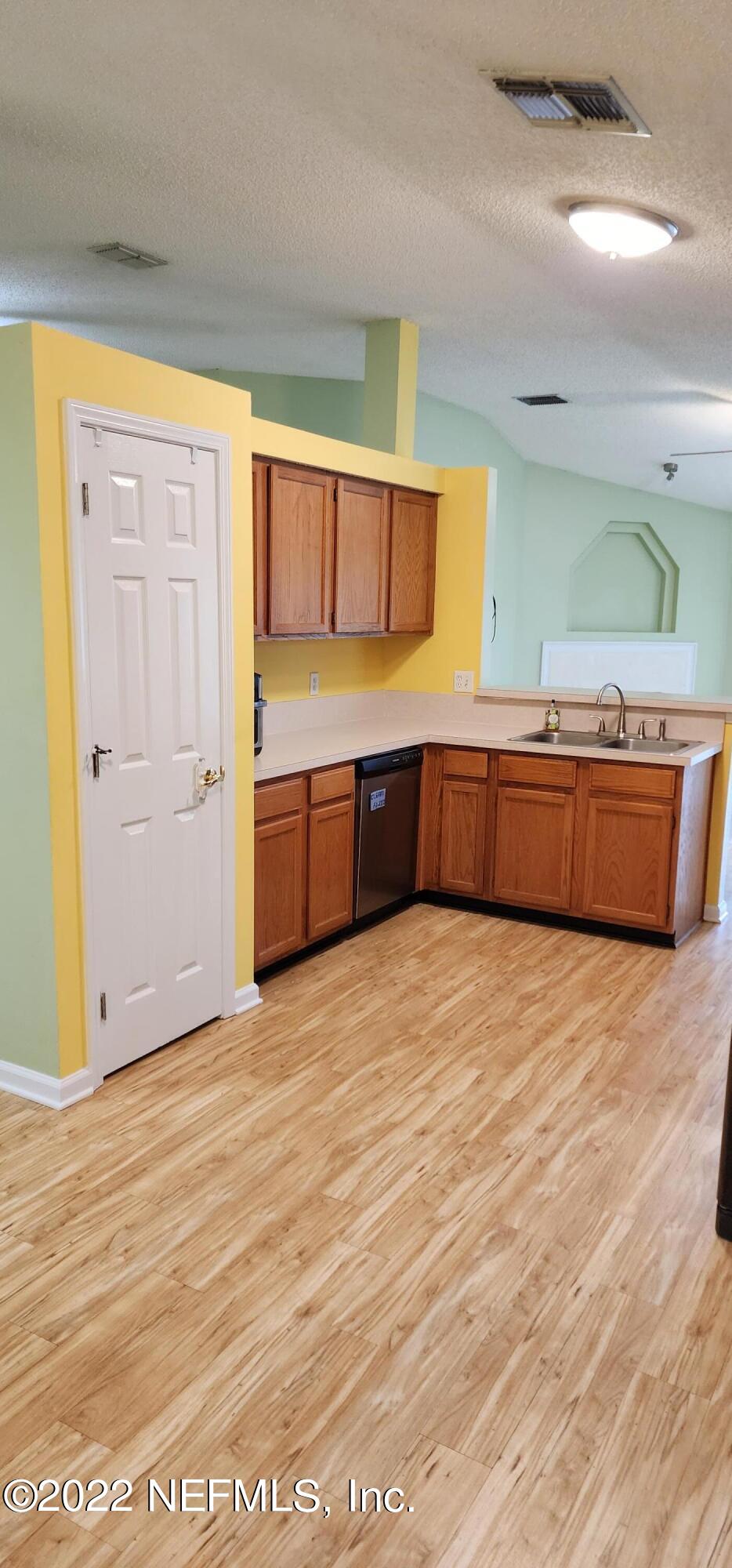 1641 Spring Oaks Lane Jacksonville, FL 32221 - Photo 11 of 40 a large kitchen with stainless steel appliances wooden floor and a window