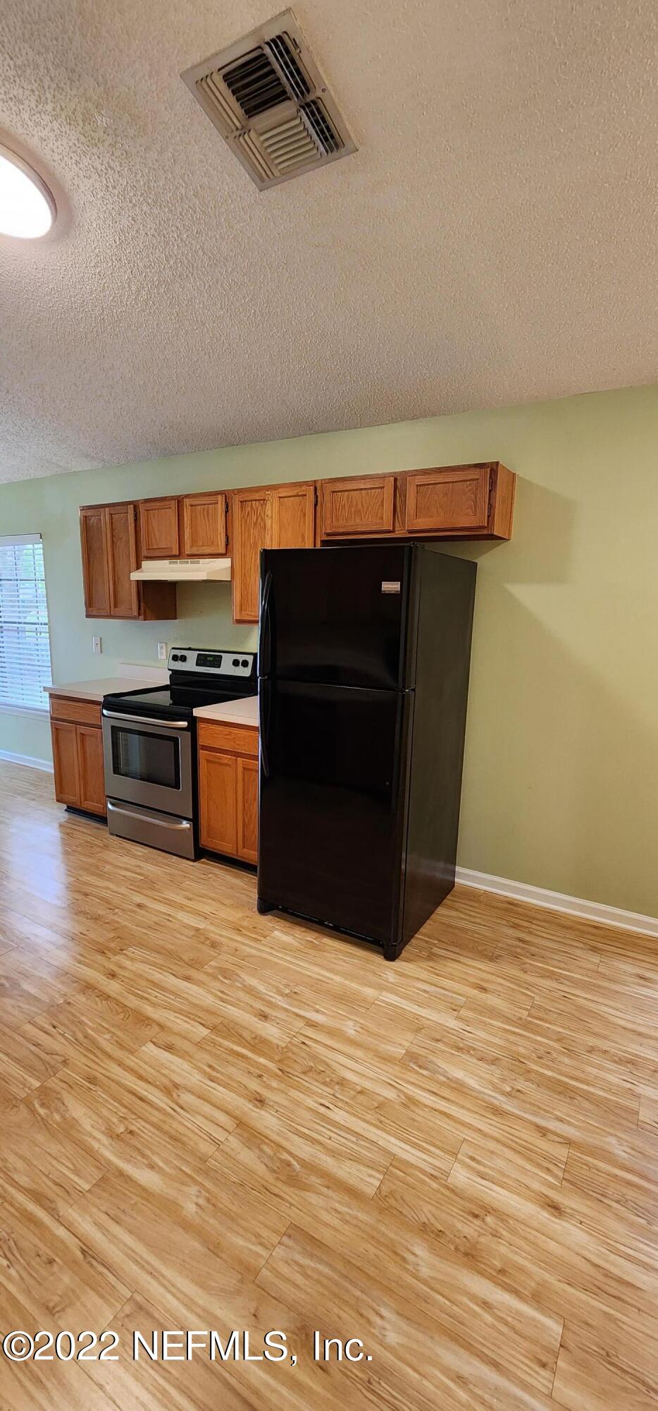 1641 Spring Oaks Lane Jacksonville, FL 32221 - Photo 12 of 40 a view of kitchen with wooden cabinets