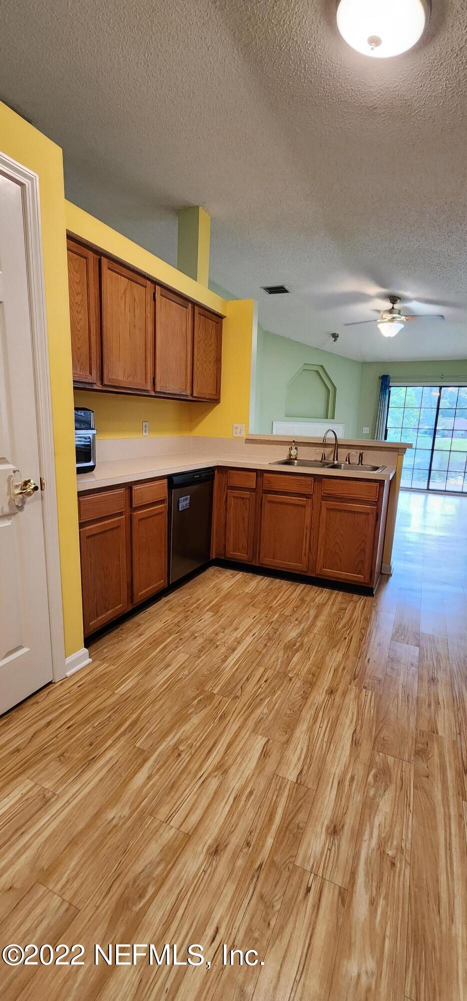 1641 Spring Oaks Lane Jacksonville, FL 32221 - Photo 13 of 40 a large kitchen with stainless steel appliances a large counter top a stove and a refrigerator