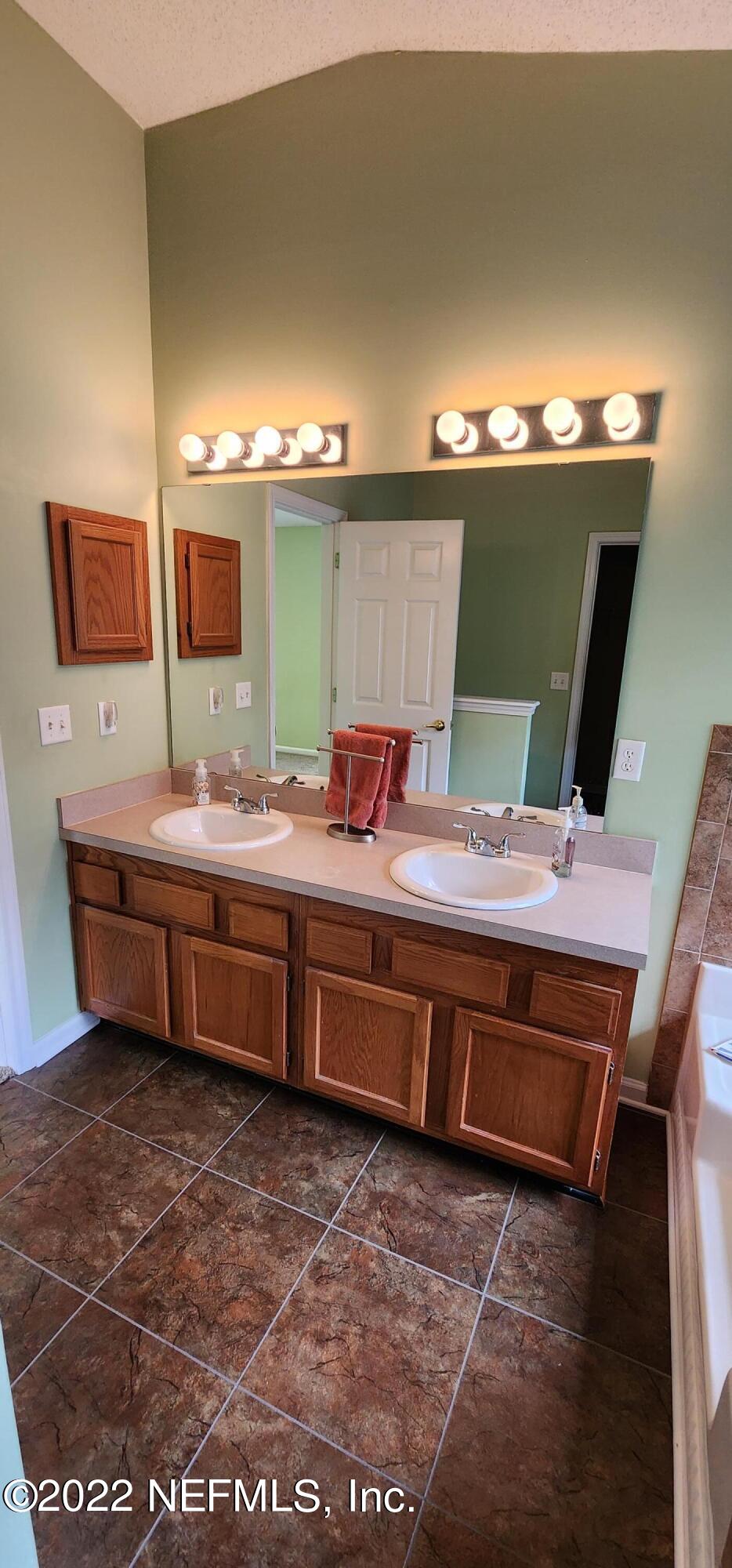 1641 Spring Oaks Lane Jacksonville, FL 32221 - Photo 19 of 40 a bathroom with a sink and a mirror
