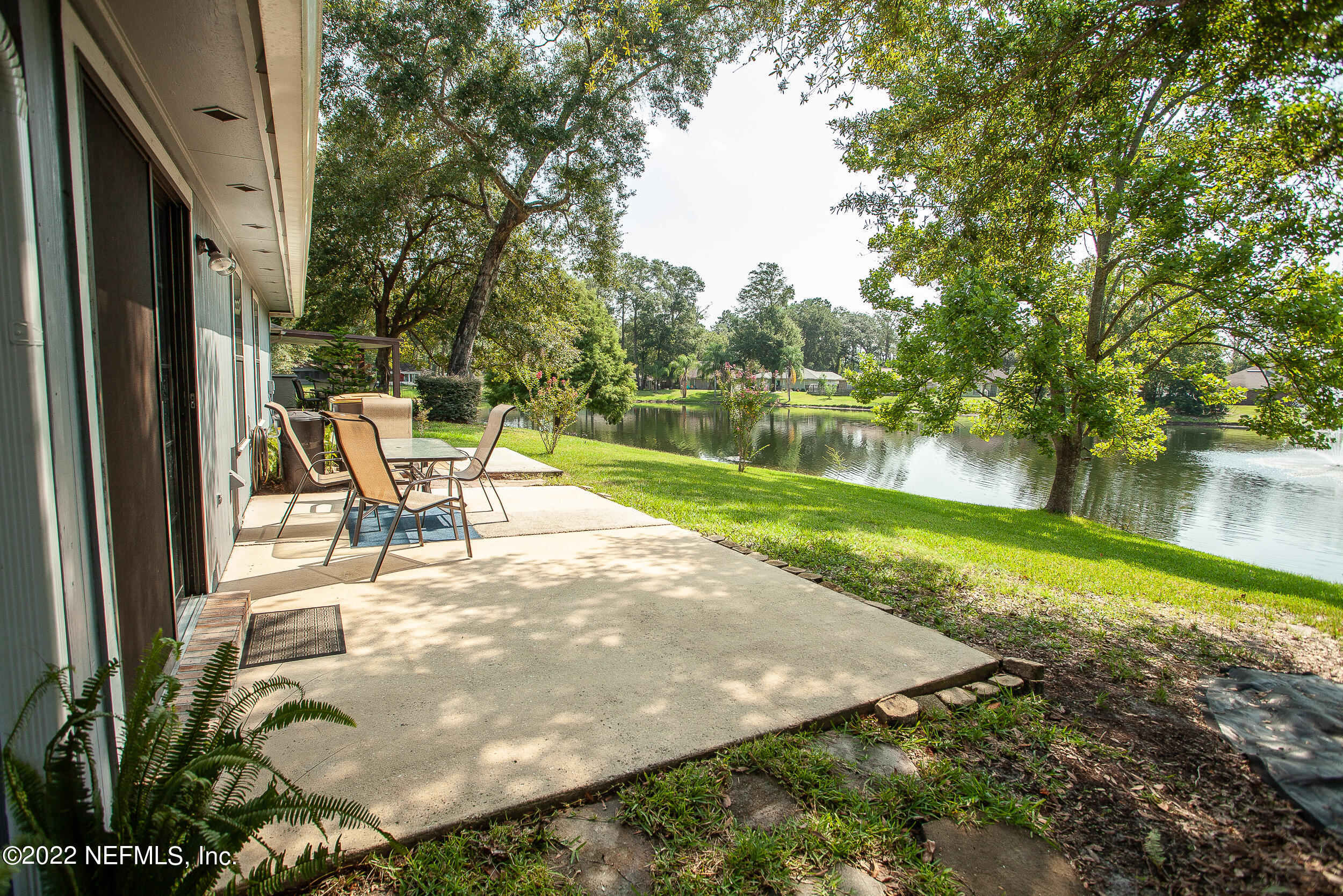 1641 Spring Oaks Lane Jacksonville, FL 32221 - Photo 3 of 40 a view of a lake with a yard and large trees