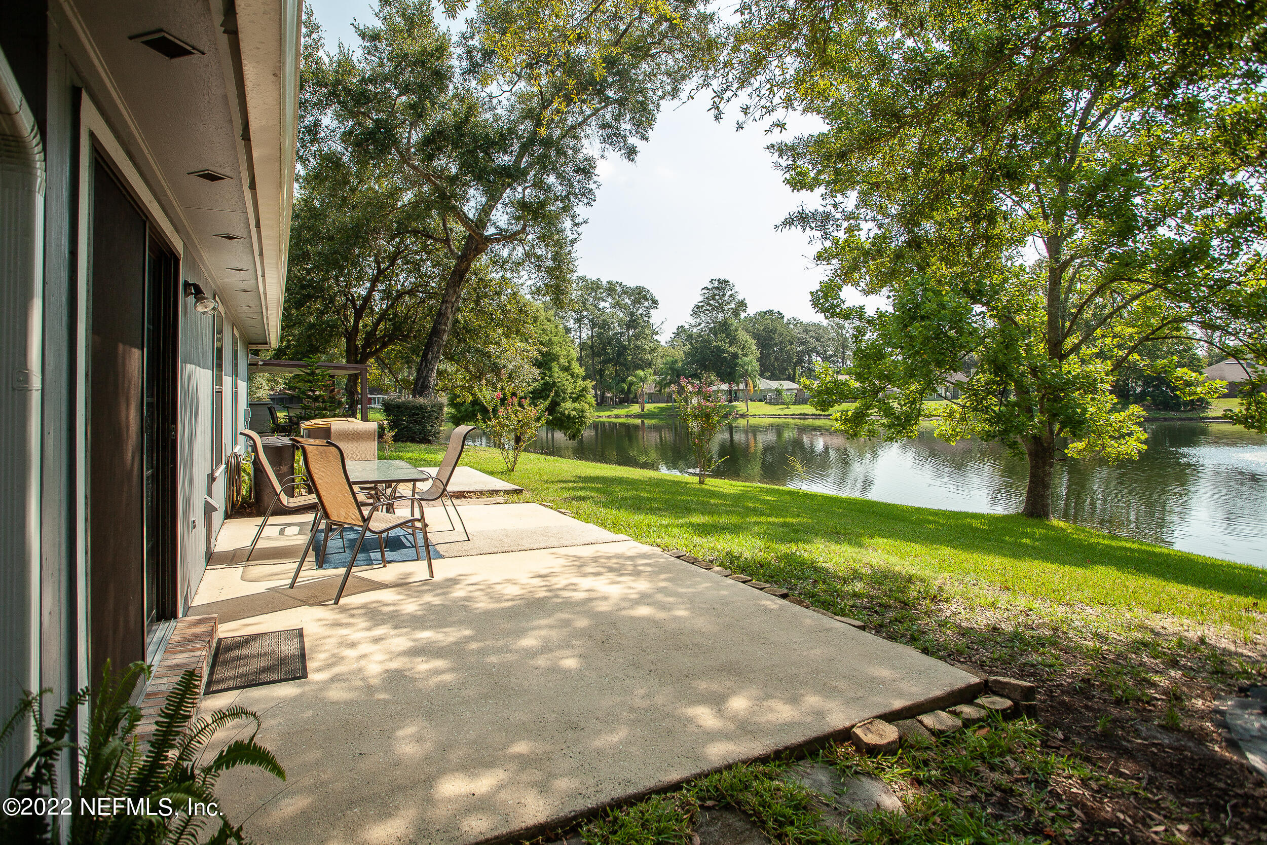 1641 Spring Oaks Lane Jacksonville, FL 32221 - Photo 32 of 40 a view of a lake with a yard and a large tree