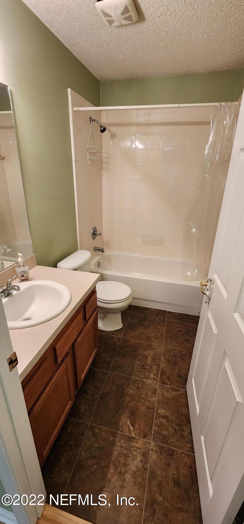 1641 Spring Oaks Lane Jacksonville, FL 32221 - Photo 35 of 40 a bathroom with a sink a toilet and shower