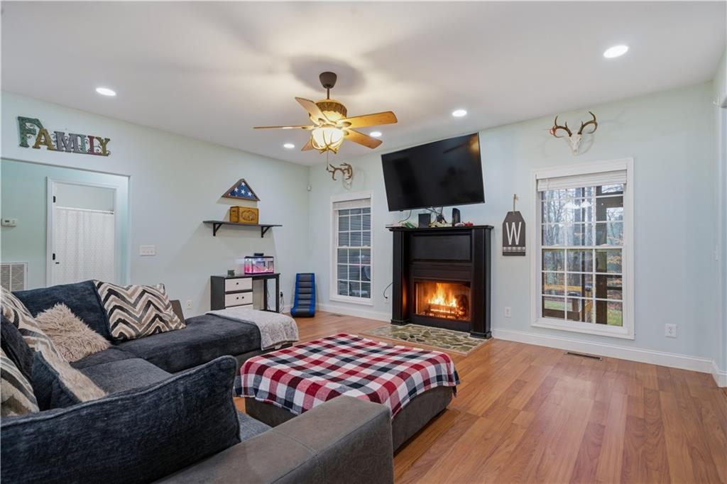 323 Lloyd Way Resaca, GA 30735 - Photo 15 of 43 a living room with furniture a flat screen tv and a fireplace