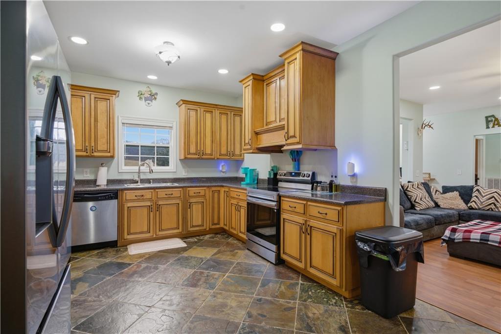 323 Lloyd Way Resaca, GA 30735 - Photo 18 of 43 a kitchen with a sink stove and cabinets