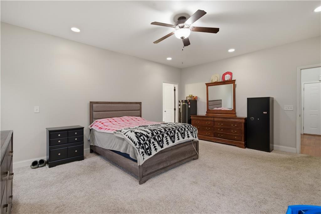 323 Lloyd Way Resaca, GA 30735 - Photo 23 of 43 a spacious bedroom with a bed and a ceiling fan