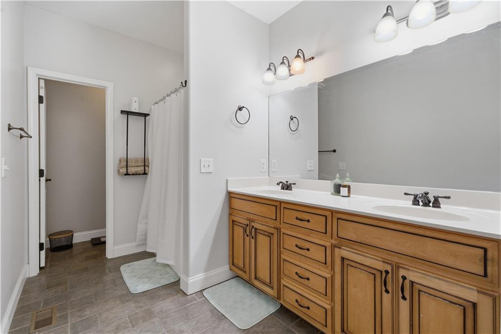 323 Lloyd Way Resaca, GA 30735 - Photo 25 of 43 a spacious bathroom with double vanity a sink and a mirror