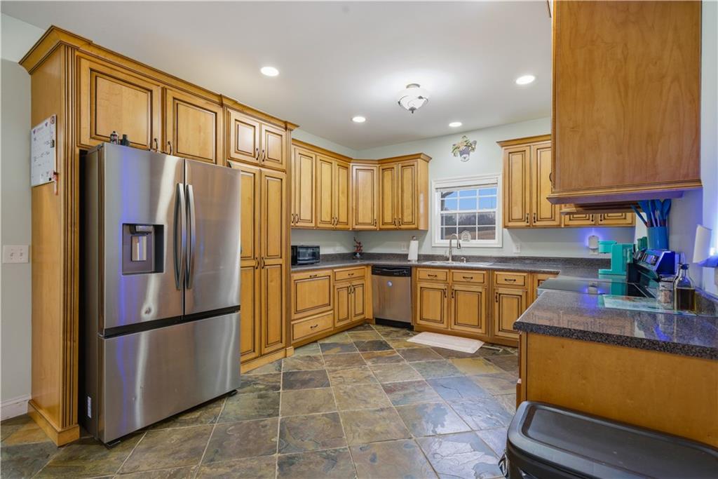 323 Lloyd Way Resaca, GA 30735 - Photo 3 of 43 a kitchen with granite countertop stainless steel appliances a refrigerator a sink a counter top space and cabinets