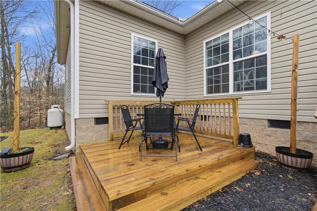 323 Lloyd Way Resaca, GA 30735 - Photo 34 of 43 a view of a patio with table and chairs and wooden floor