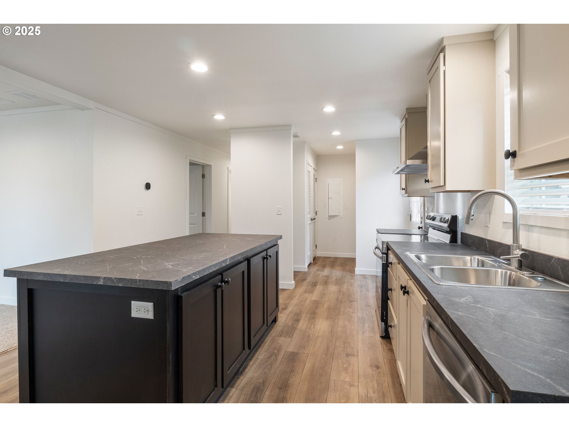 631 East Ellendale Avenue, Unit 206 Dallas, OR 97338 - Photo 13 of 30 a kitchen with a sink a counter top space stainless steel appliances and cabinets