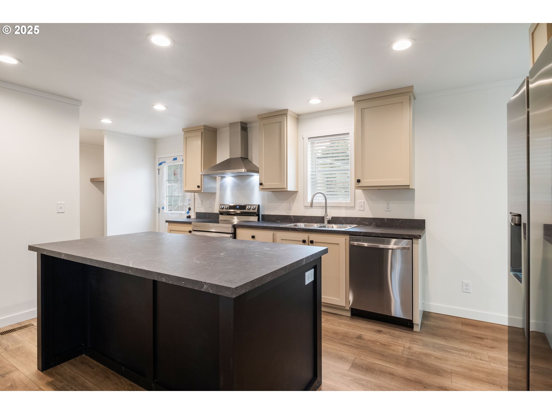 631 East Ellendale Avenue, Unit 206 Dallas, OR 97338 - Photo 14 of 30 a kitchen with kitchen island a sink stainless steel appliances and cabinets