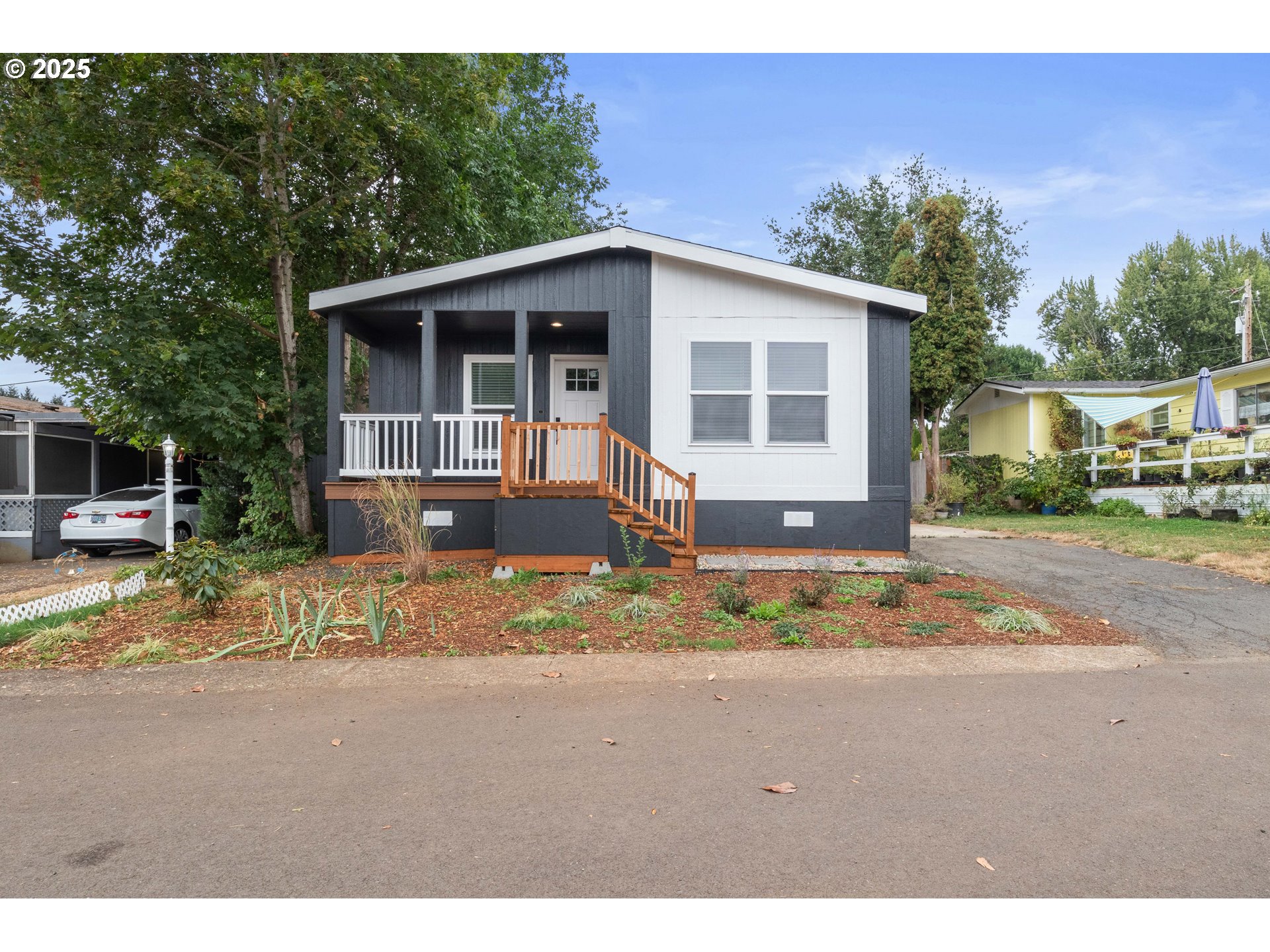 631 East Ellendale Avenue, Unit 206 Dallas, OR 97338 - Photo 2 of 30 a view of a house with a yard and large tree