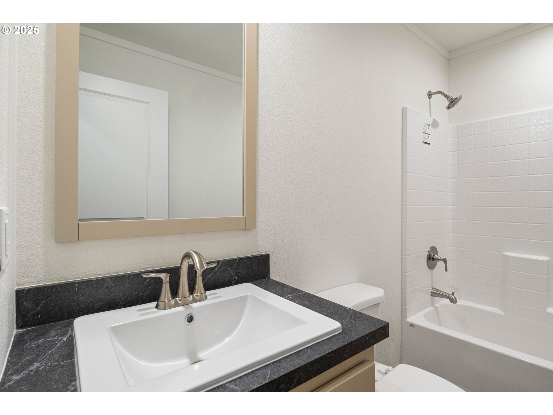 631 East Ellendale Avenue, Unit 206 Dallas, OR 97338 - Photo 21 of 30 a bathroom with a sink a bath tub and a toilet