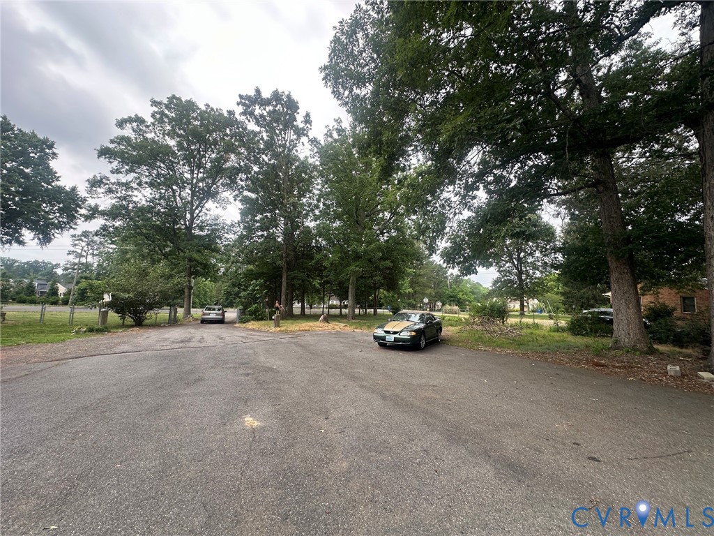 9808 Reams Road North Chesterfield, VA 23236 - Photo 6 of 8 a view of a road with trees and cars parked