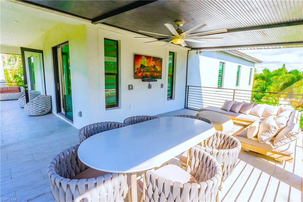 4064 Full Moon Court Naples, FL 34112 - Photo 13 of 50 a balcony with table and chairs