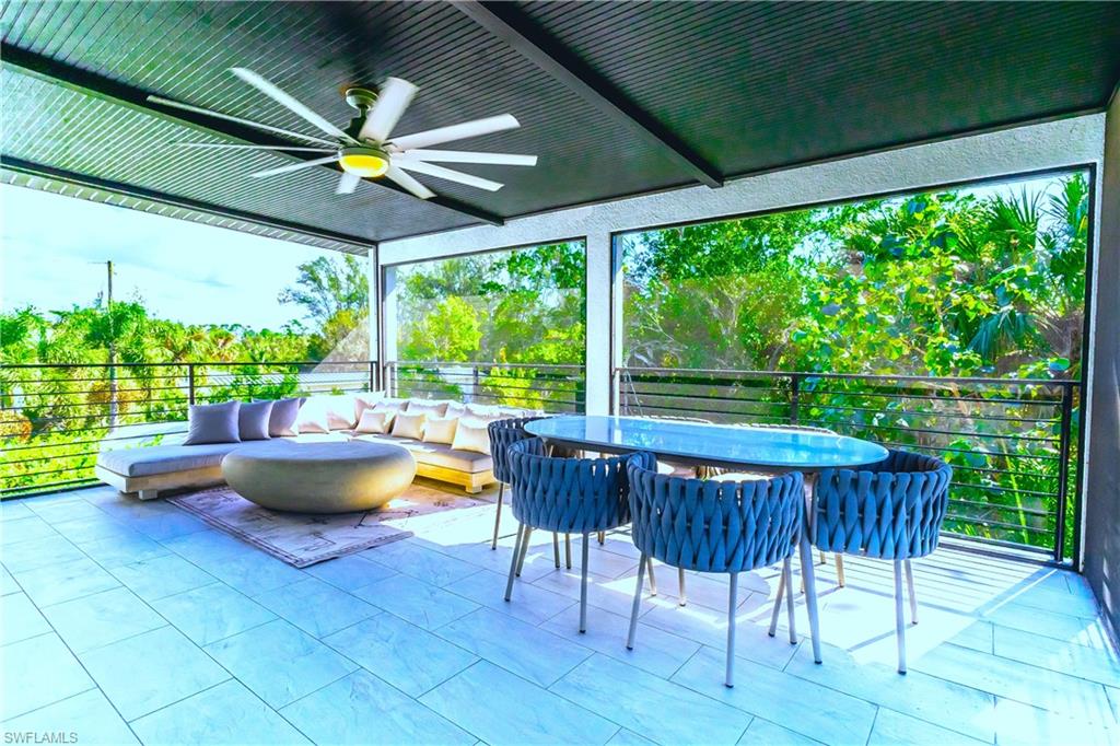 4064 Full Moon Court Naples, FL 34112 - Photo 14 of 50 a view of swimming pool with a table and chairs