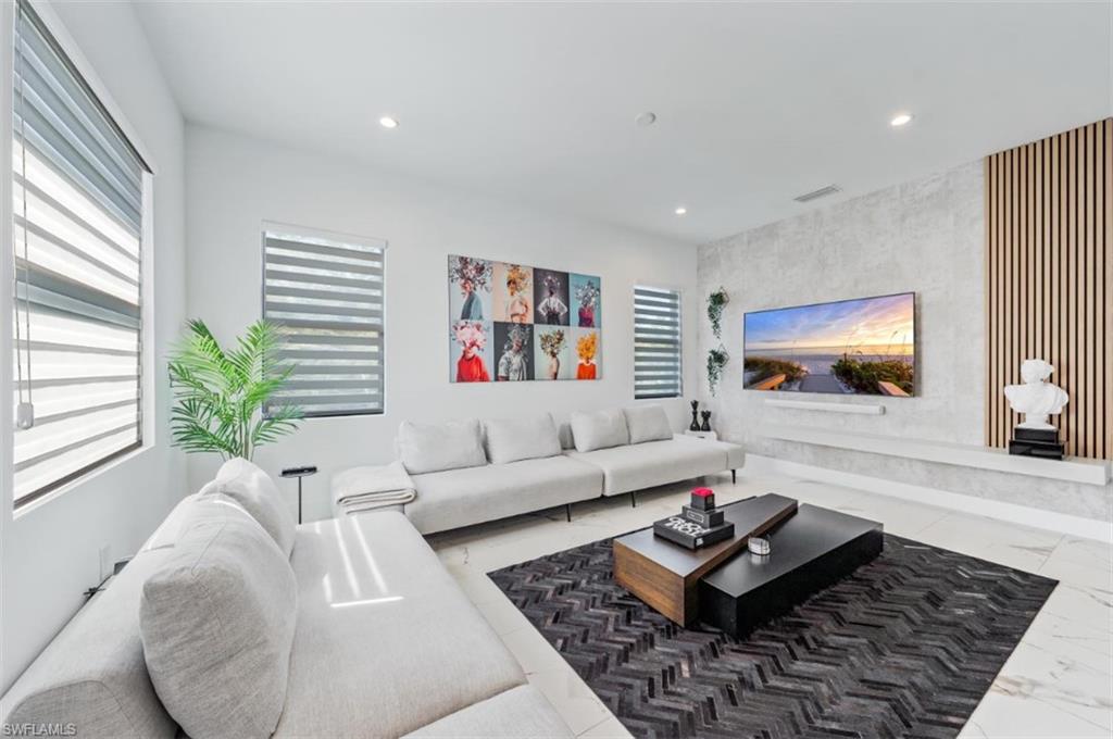 4064 Full Moon Court Naples, FL 34112 - Photo 18 of 50 a living room with furniture and a flat screen tv