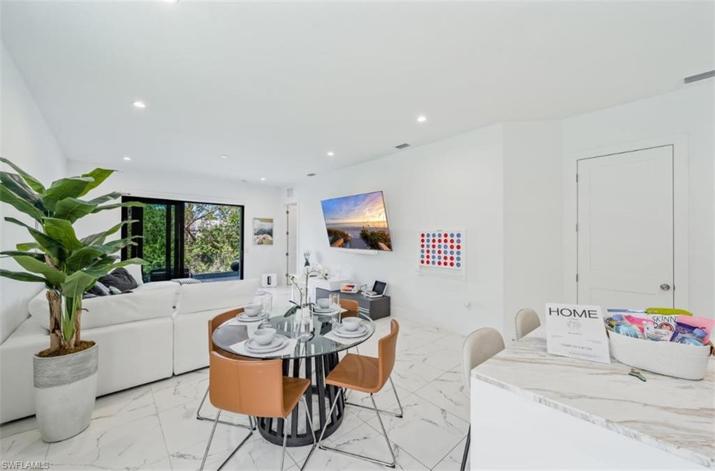 4064 Full Moon Court Naples, FL 34112 - Photo 19 of 50 a living room with furniture and a potted plant